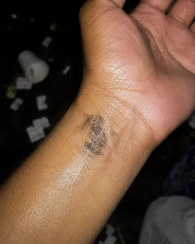 A door stamp on a wrist
